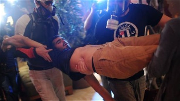 Protesters-carry-a-wounded-person-inside-Divan-Hotel-near-Gezi-Park-in-Istanbul-June-15-2013.-AFP